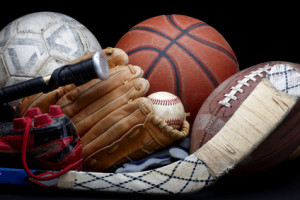 Close up shot of old soccer ball, basketball, baseball, football, bat, hockey stick, baseball glove and cleats